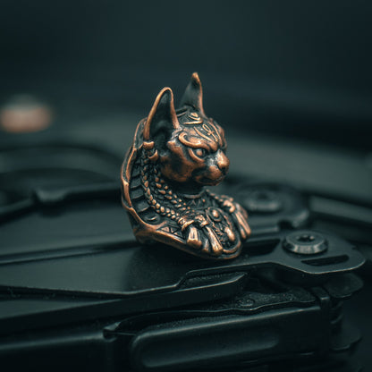 Copper Close-up of Bastet paracord bead with intricate Egyptian-style carvings, ideal for knife lanyards and custom EDC accessories.
