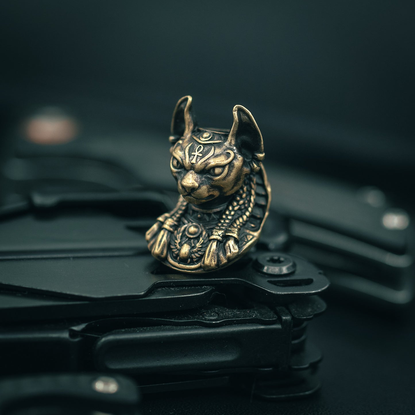 Brass Close-up of Bastet paracord bead with intricate Egyptian-style carvings, ideal for knife lanyards and custom EDC accessories.