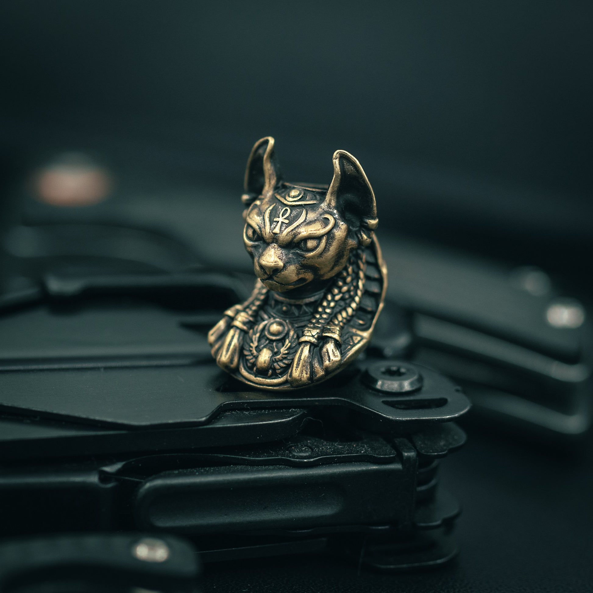 Brass Close-up of Bastet paracord bead with intricate Egyptian-style carvings, ideal for knife lanyards and custom EDC accessories.