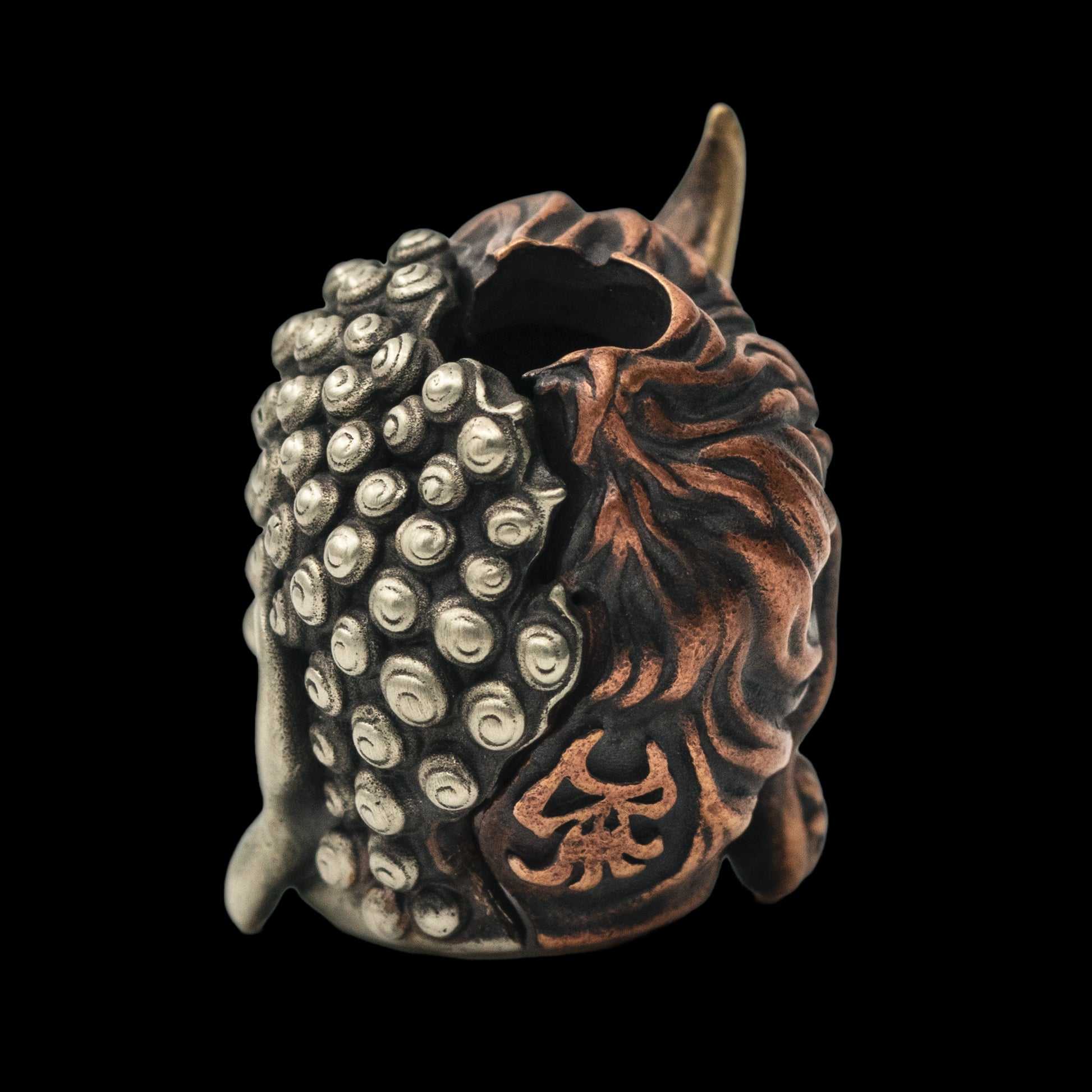 Buddha or Devil Paracord Bead three different metals edc back side — copper, brass, and white brass — fused together into a single