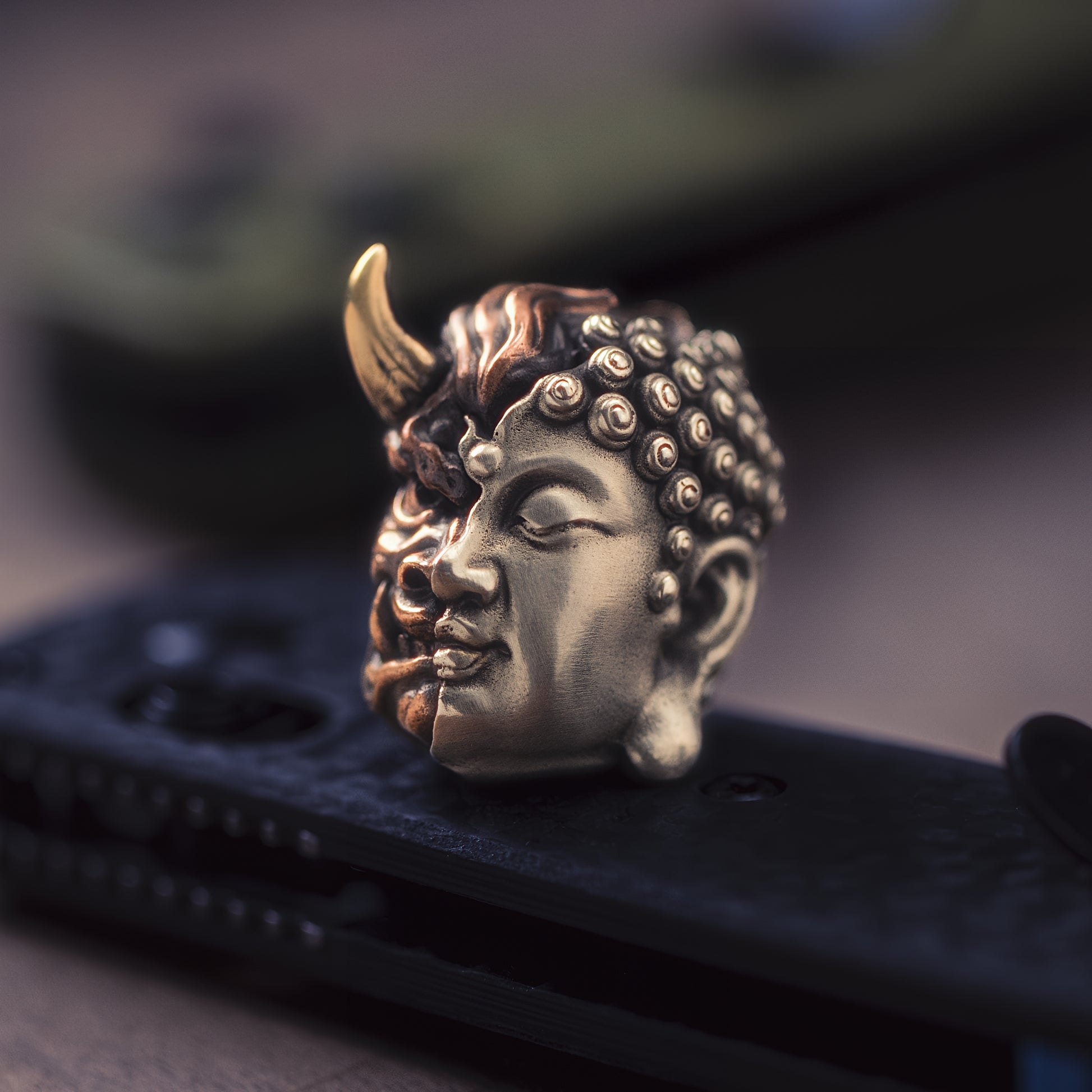Buddha or Devil Paracord Bead on knife three different metals edc — copper, brass, and white brass — fused together into a single