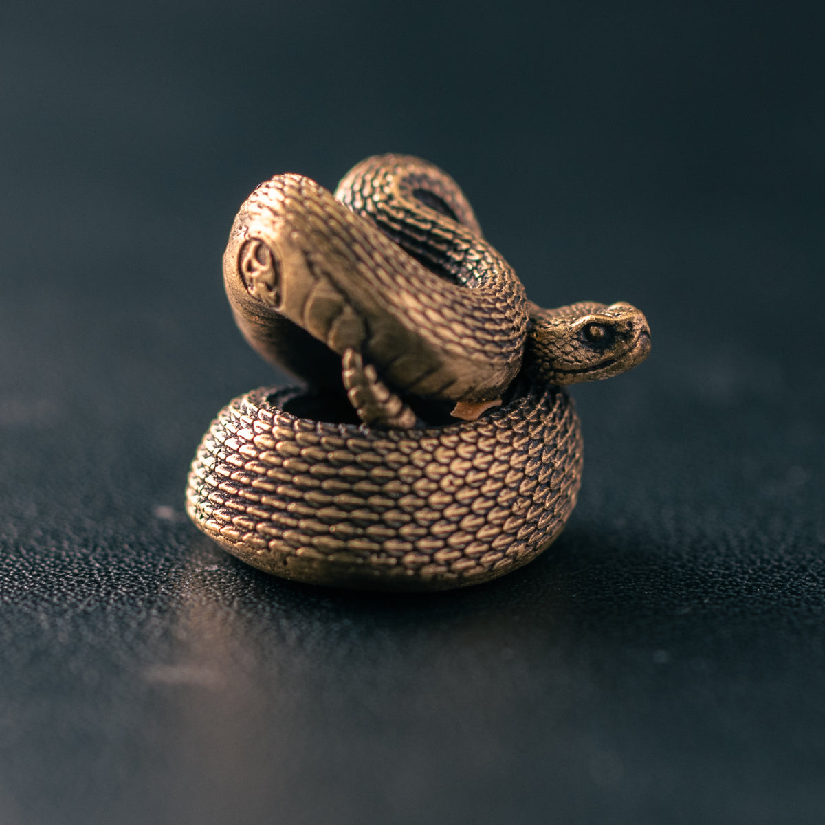 Antique brass rattlesnake paracord bead with detailed scales and coiled sculptural body, original ShadowEDC EDC lanyard bead.