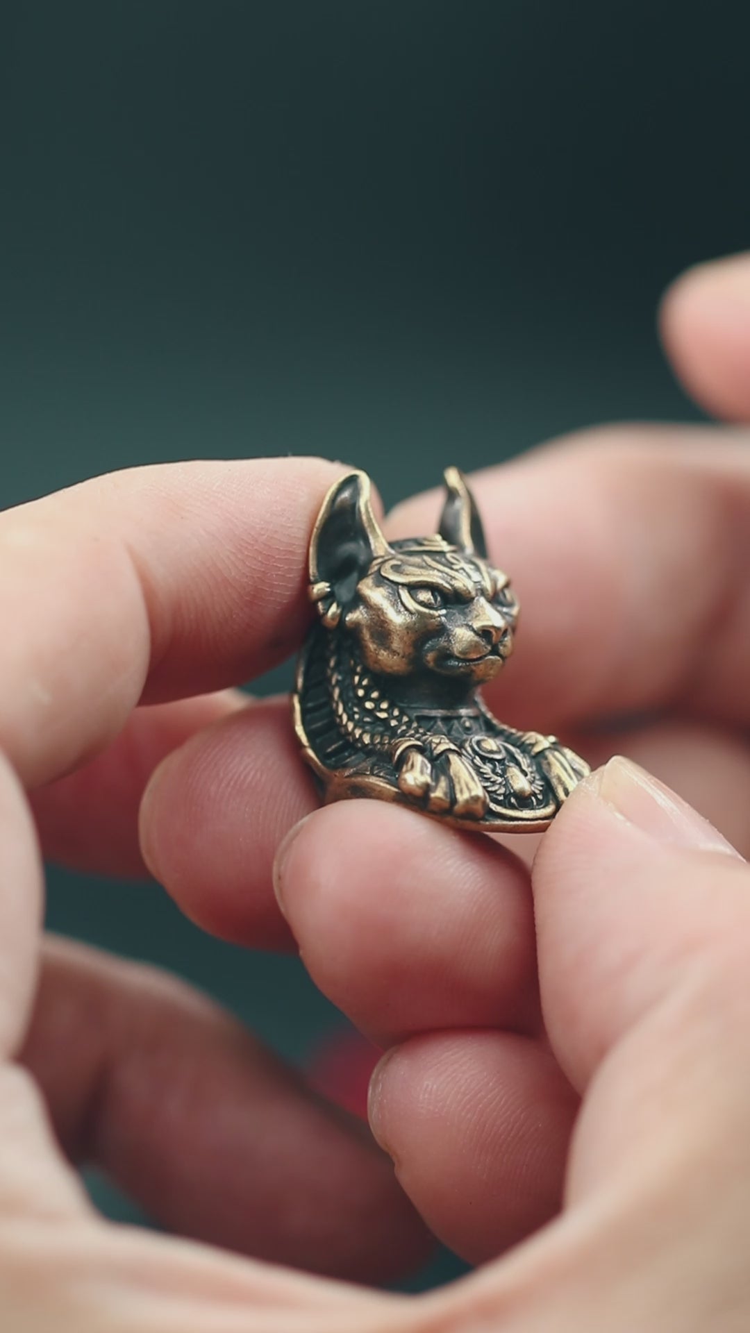 Close-up of Bastet paracord bead with intricate Egyptian-style carvings, ideal for knife lanyards and custom EDC accessories.