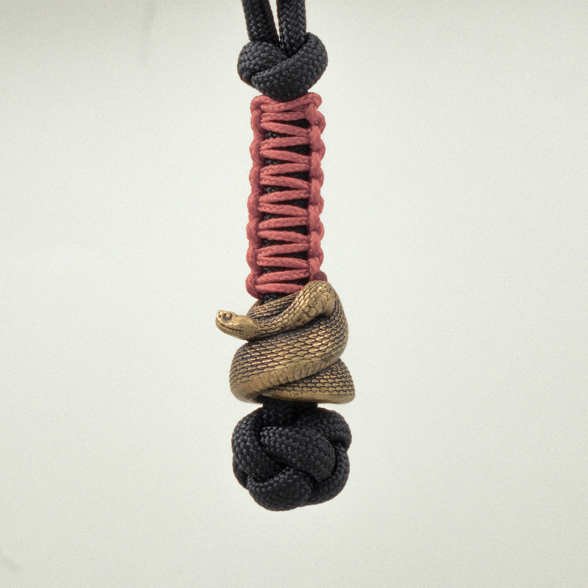 Underside of the Rattlesnake EDC bead showing the coiled snake structure and approximately 6 mm opening for 550 paracord.