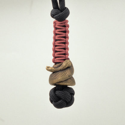 Underside of the Rattlesnake EDC bead showing the coiled snake structure and approximately 6 mm opening for 550 paracord.