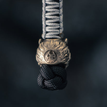 Macro detail of the ShadowEDC Wild Tiger bead showing the hand-finished tiger face, deep carved stripes and textured metal surface.