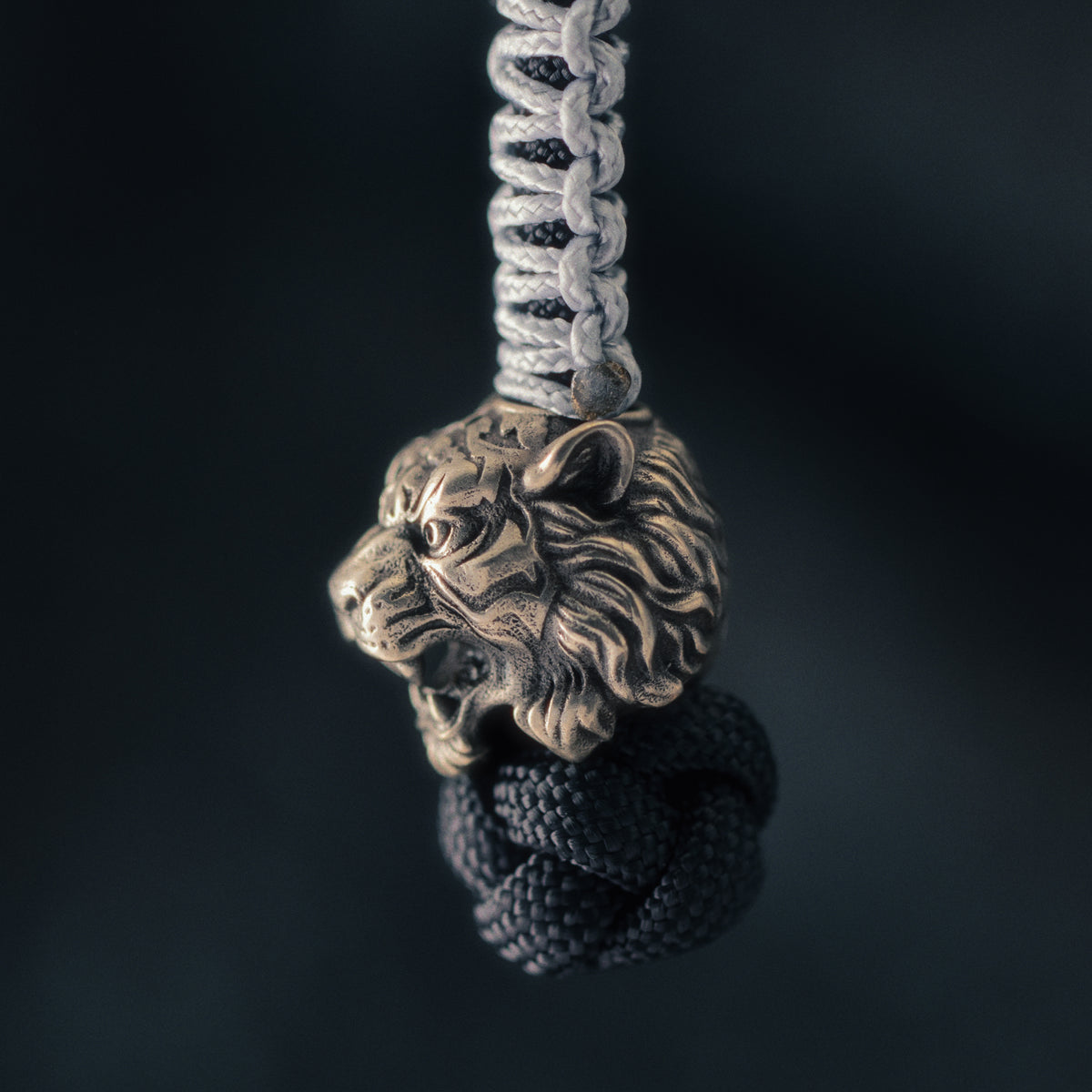 Side view of the Wild Tiger paracord bead showing the sculpted muzzle, exposed teeth, cheek structure and layered fur.v