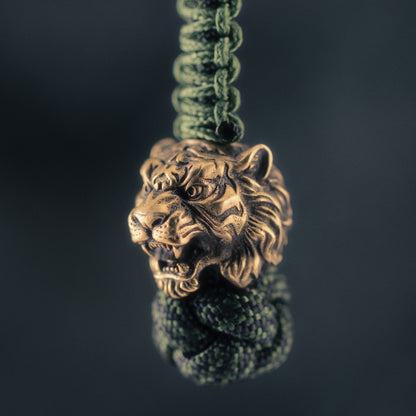 Antique brass Wild Tiger paracord bead with open jaws, sculpted stripes and detailed fur, original ShadowEDC EDC lanyard bead.